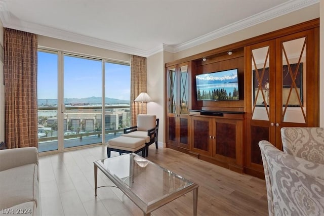 living room with crown molding, light hardwood / wood-style flooring, french doors, and a water view