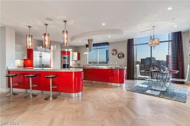 kitchen featuring range hood, white cabinetry, light parquet flooring, and built in appliances