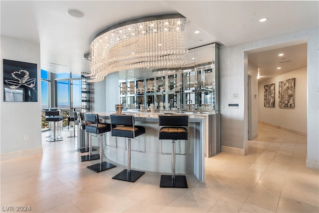 bar with white cabinetry, floor to ceiling windows, a chandelier, and light tile patterned flooring