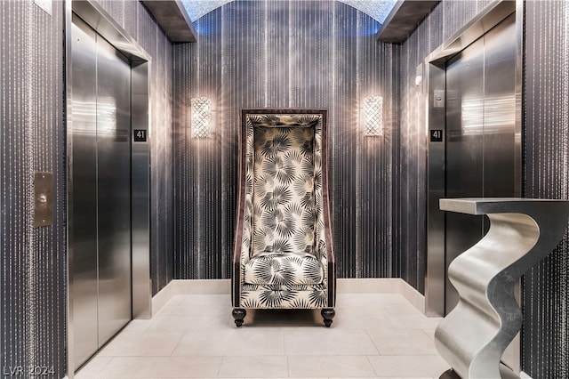 bathroom with elevator and tile patterned floors