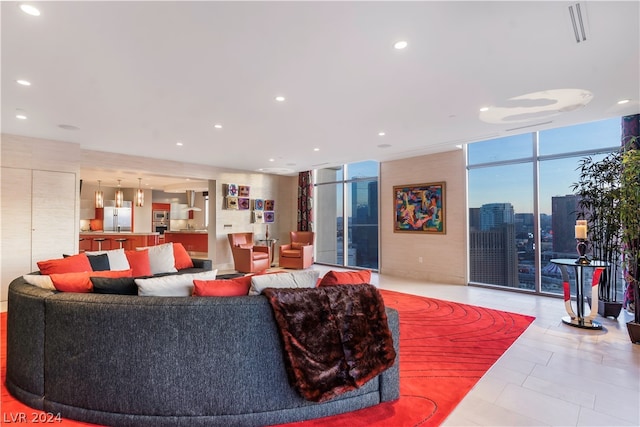 tiled living room featuring expansive windows