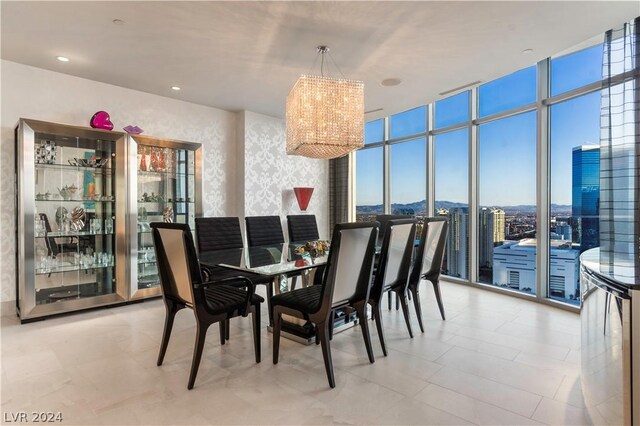 dining room with expansive windows, a notable chandelier, and light tile patterned floors