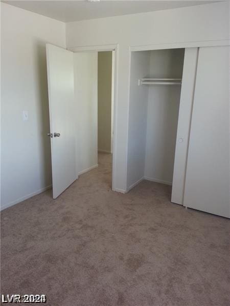 unfurnished bedroom featuring light carpet