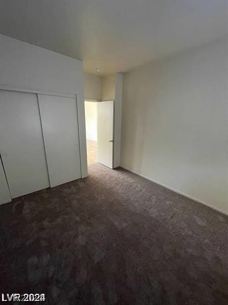 unfurnished bedroom with carpet floors and a closet