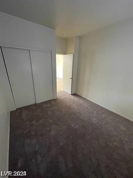 unfurnished bedroom with a closet and carpet