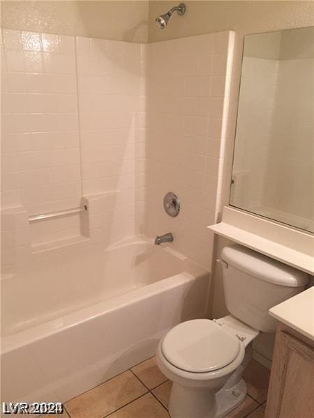 full bathroom with washtub / shower combination, toilet, tile patterned flooring, and vanity