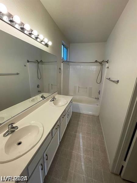 bathroom featuring shower / tub combination and vanity