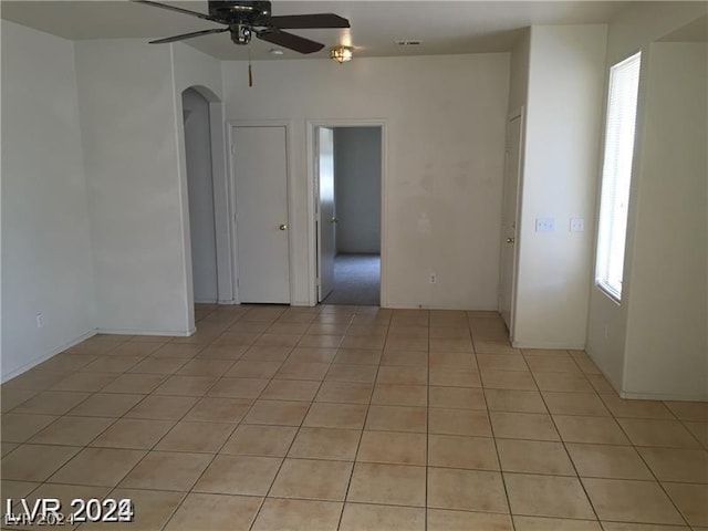 unfurnished room with ceiling fan and light tile patterned floors