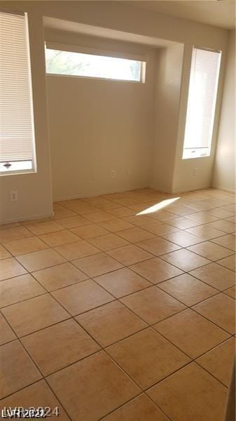 unfurnished room with light tile patterned flooring