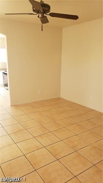 tiled empty room with ceiling fan