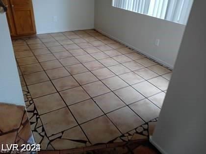 unfurnished room featuring light tile patterned floors