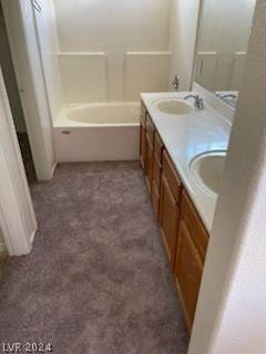 bathroom with vanity and a tub to relax in