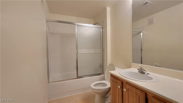 full bath featuring toilet, shower / bath combination with glass door, visible vents, and vanity