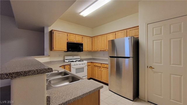 kitchen with black microwave, a sink, white range with gas cooktop, freestanding refrigerator, and dark countertops