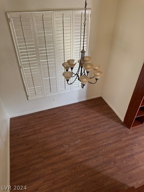 interior details with an inviting chandelier and wood-type flooring