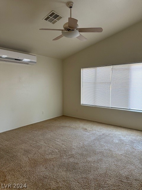 carpeted empty room with ceiling fan, a healthy amount of sunlight, a wall mounted AC, and lofted ceiling