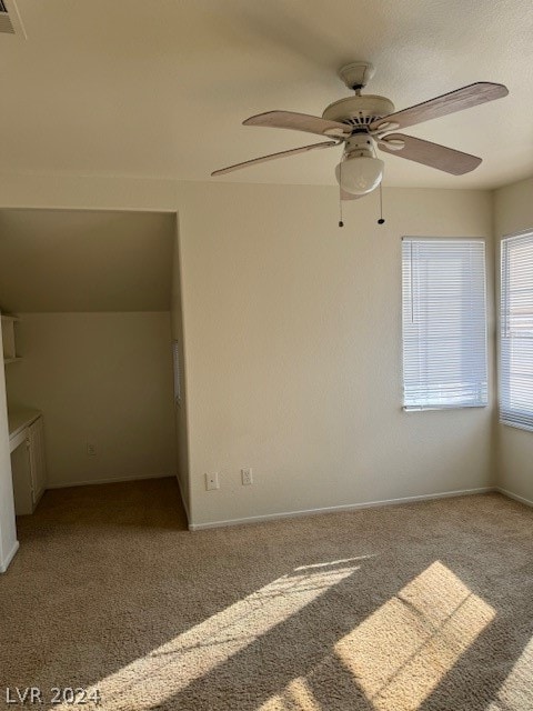 interior space with carpet floors and ceiling fan