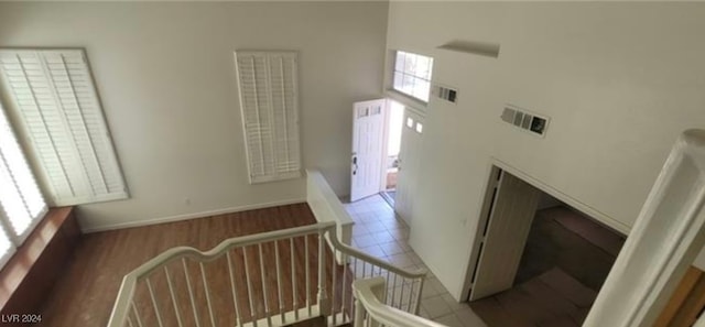 stairs with a high ceiling and tile patterned flooring