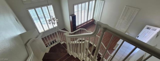 stairway featuring a towering ceiling