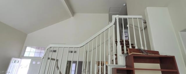 staircase featuring a towering ceiling