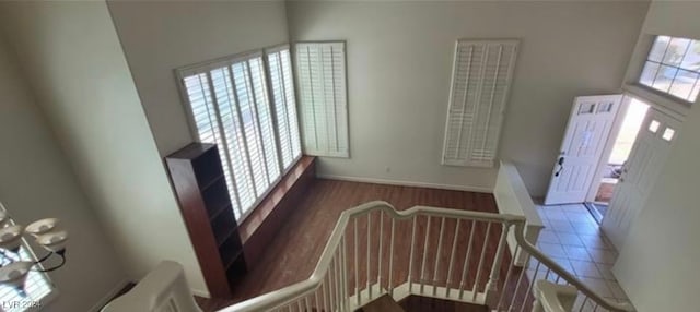 tiled entryway featuring a wealth of natural light and a high ceiling