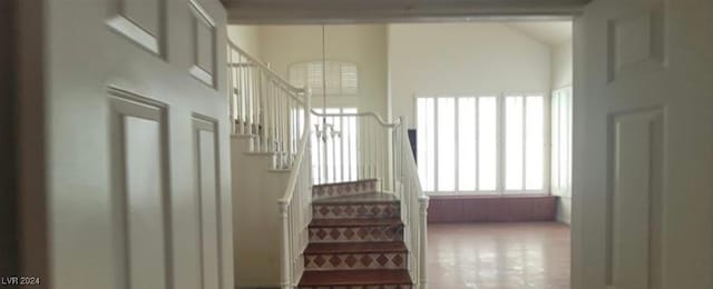 stairs featuring a towering ceiling