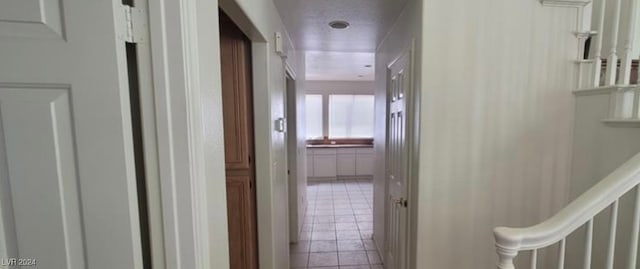 hallway featuring light tile patterned floors