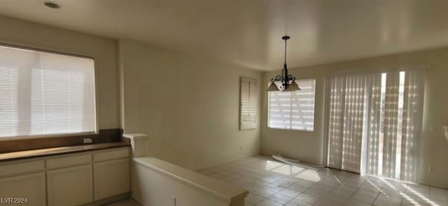 kitchen with light tile patterned flooring, an inviting chandelier, and decorative light fixtures