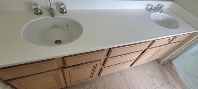 bathroom with tile patterned flooring and vanity