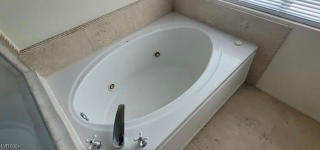 bathroom featuring a bath and tile patterned flooring