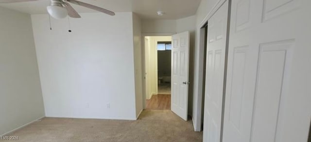 unfurnished bedroom with ceiling fan and light carpet