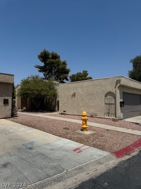 view of side of home featuring a garage