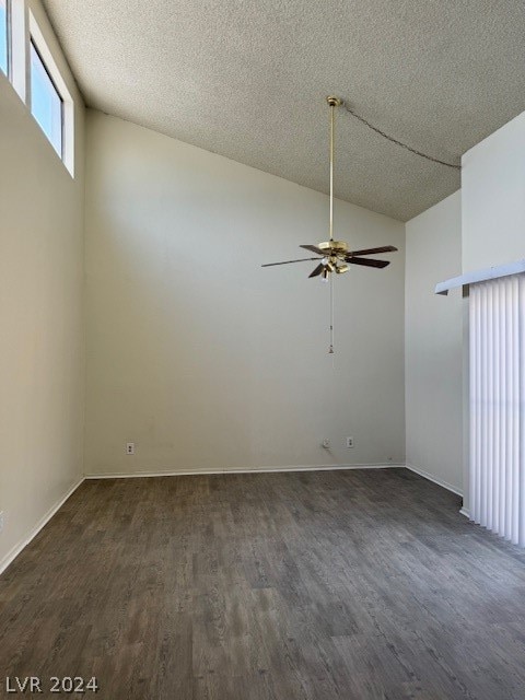 unfurnished room featuring vaulted ceiling, a textured ceiling, ceiling fan, and dark hardwood / wood-style floors