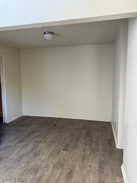 spare room with a textured ceiling and hardwood / wood-style flooring