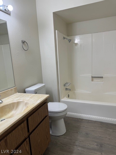 full bathroom with vanity, shower / bathing tub combination, wood-type flooring, and toilet