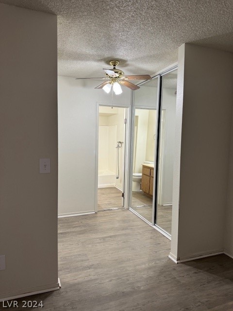 interior space featuring a textured ceiling and hardwood / wood-style floors