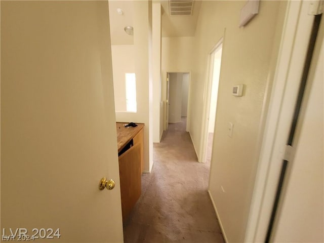 hallway featuring carpet