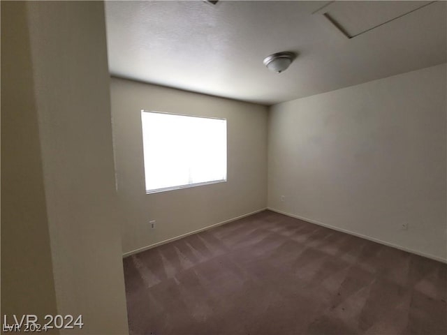 empty room featuring dark colored carpet