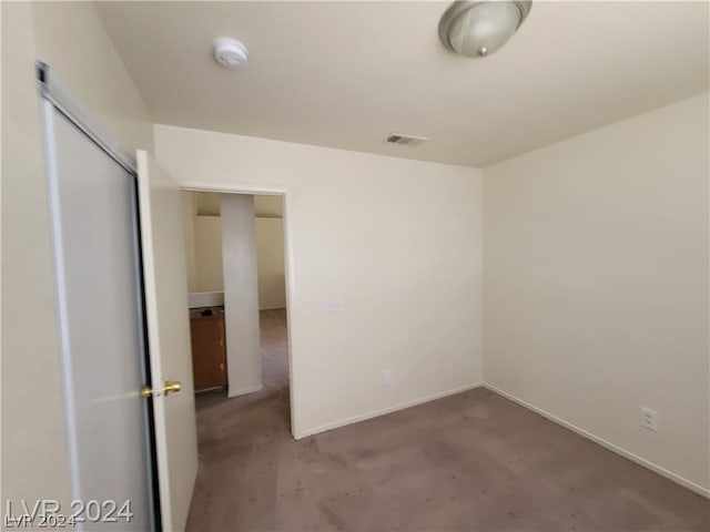 unfurnished room with concrete floors