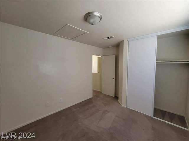 unfurnished bedroom featuring carpet floors and a closet