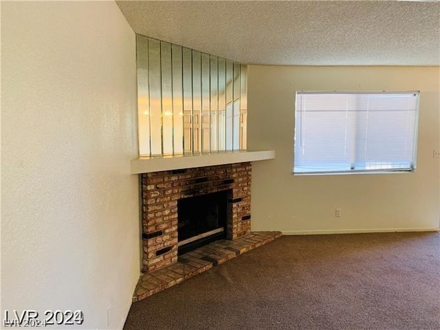 unfurnished living room with a textured ceiling, a brick fireplace, and carpet flooring