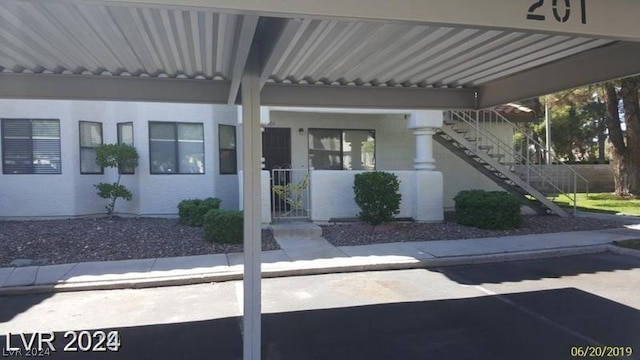 property entrance featuring a carport