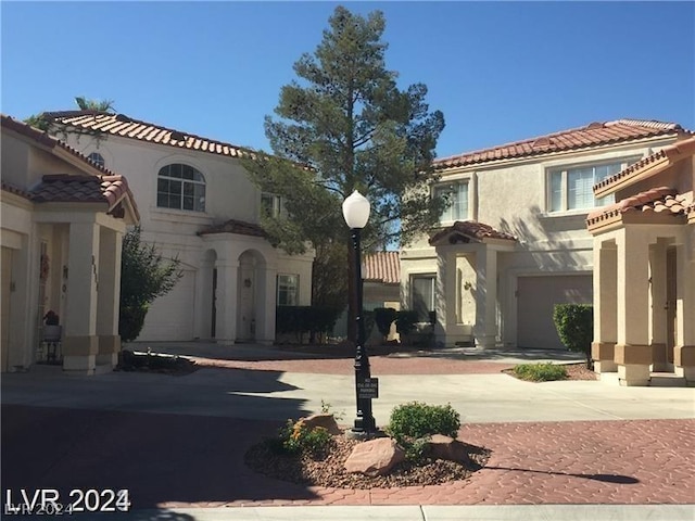 mediterranean / spanish-style home with a garage