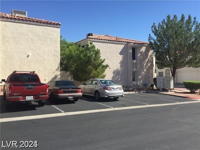 view of parking with mail boxes