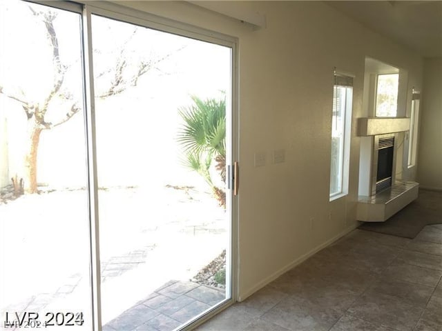 doorway to outside featuring a tiled fireplace