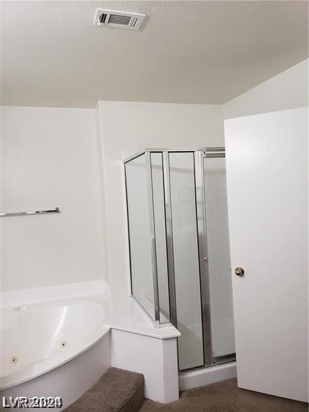 bathroom featuring separate shower and tub