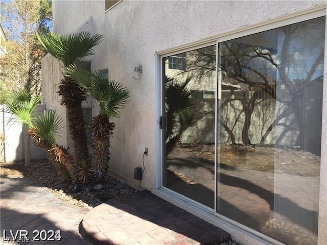 doorway to property with a patio area