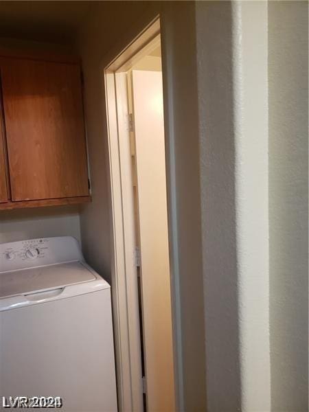 laundry room with washer / dryer and cabinets