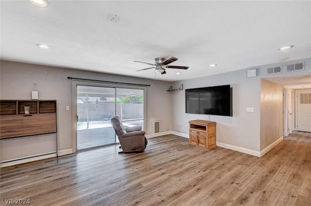 unfurnished living room featuring ceiling fan and light hardwood / wood-style floors