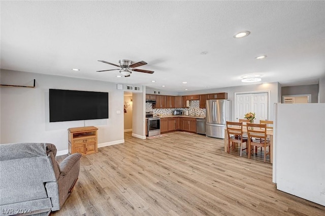 living room with light hardwood / wood-style floors and ceiling fan